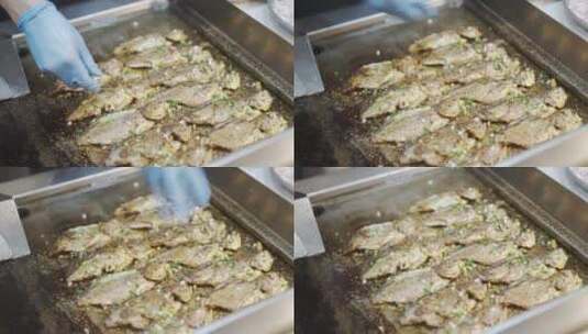 厨师使用铲子把鱼翻过来煎烤高清在线视频素材下载