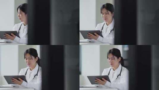 年轻女医生在办公室使用笔记本和平板工作高清在线视频素材下载
