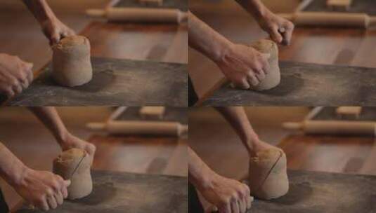 一名男子在陶艺作坊揉泥。男性手特写揉泥。高清在线视频素材下载