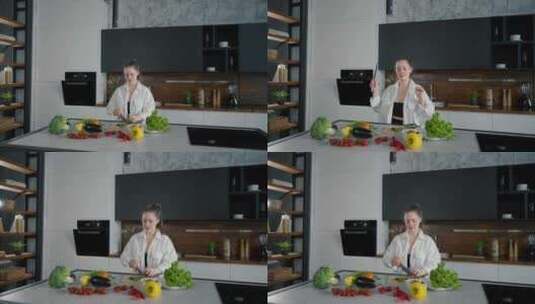 年轻女子在厨房做饭跳舞女孩做饭用耳机听音高清在线视频素材下载