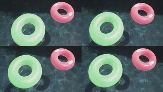 两个五颜六色的游泳圈漂浮在游泳池的表面高清在线视频素材下载