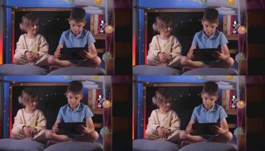 儿童在儿童之家小屋的平板电脑上观看有趣的高清在线视频素材下载