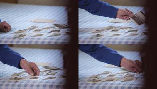 手触摸放置在桌布上的老照片高清在线视频素材下载