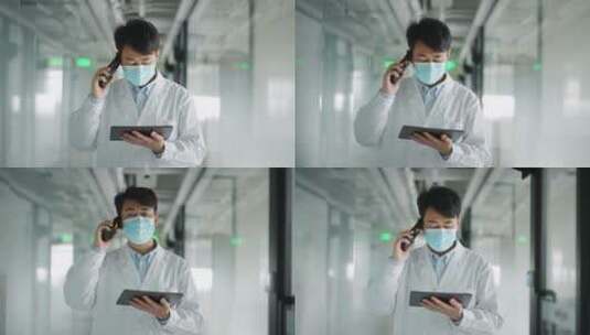 年轻医学科研人员走廊里使用平板电脑手机高清在线视频素材下载