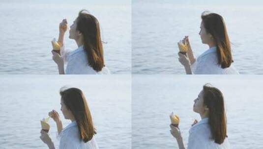 女孩在海边吃冰淇淋4k视频素材高清在线视频素材下载
