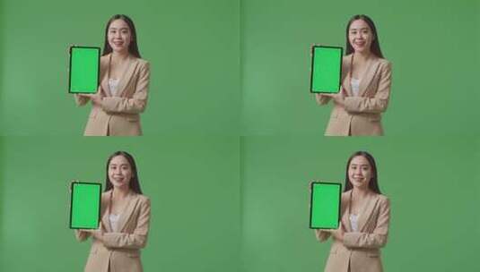 女商人在绿屏上展示平板电脑高清在线视频素材下载