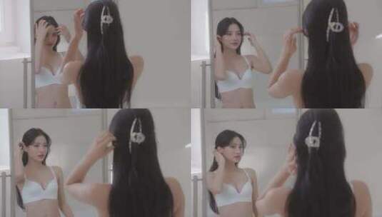 美女看镜子整理头发高清在线视频素材下载