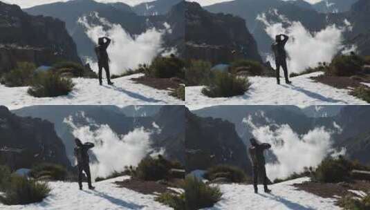男子站在雪山上拍摄山脉高清在线视频素材下载