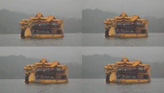 阴雨天一条龙形画舫游船行驶在西湖上高清在线视频素材下载