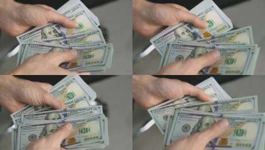 数着一叠一百美元钞票的男性手的特写镜头高清在线视频素材下载