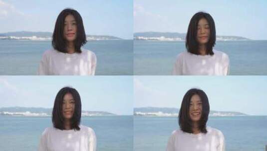 美女站在海边看着镜头微笑高清在线视频素材下载