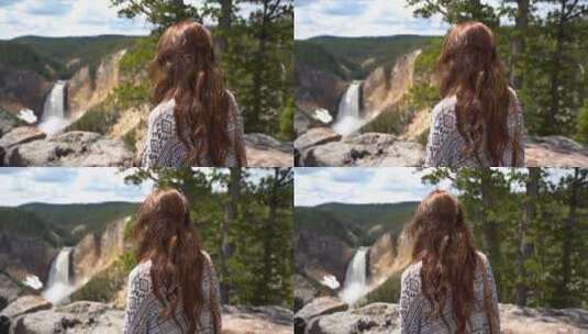 女人站在山上看瀑布高清在线视频素材下载