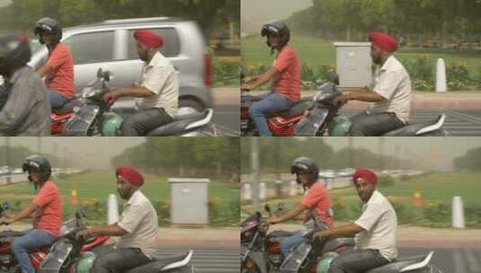 印度人在城市公路上骑摩托车高清在线视频素材下载