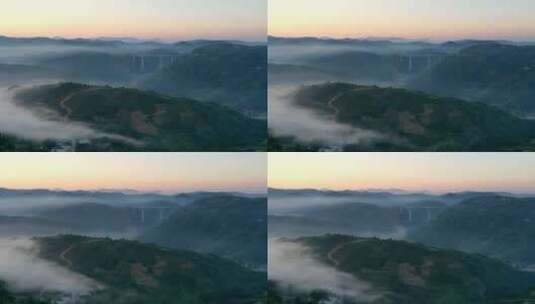 航拍清晨远山群山晨雾缭绕高架桥灯火点点高清在线视频素材下载