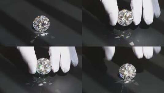 珠宝工作人员戴手套把一颗钻石拿起检查高清在线视频素材下载