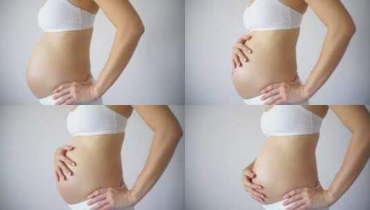 孕妇抚摸着大肚子高清在线视频素材下载
