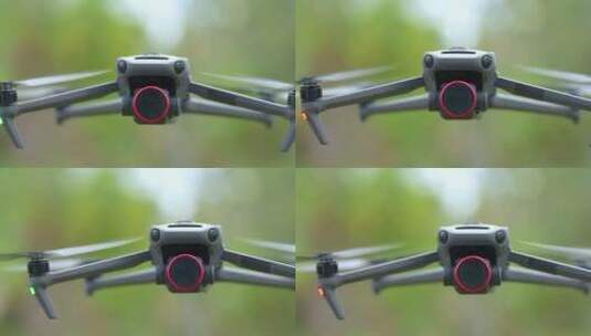 无人机与数码相机和快速旋转的螺旋桨飞行高清在线视频素材下载