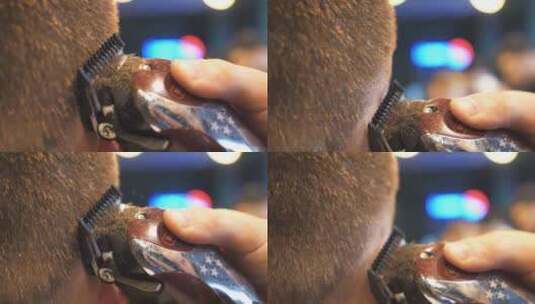 发型师用电动剃须刀剪头发的特写高清在线视频素材下载