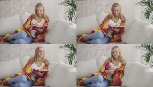 坐在沙发上看书的女人高清在线视频素材下载