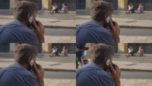 一名男子坐在街上打电话高清在线视频素材下载
