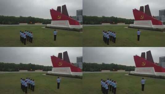 航拍面向党旗雕塑宣誓的警察队伍高清在线视频素材下载