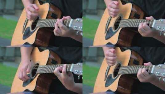 一个年轻人在户外弹吉他的特写镜头高清在线视频素材下载