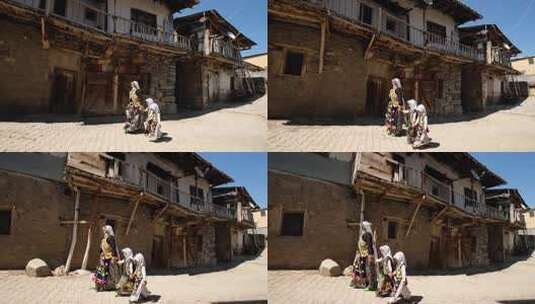 中穿着传统土耳其服装的妇女和他们的孩子走在乡村街道上高清在线视频素材下载