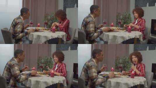 快乐迷人的非裔美国夫妇在室内享受浪漫晚餐高清在线视频素材下载
