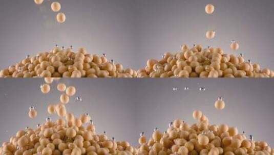 黄豆大豆慢动作掉落水中灰色背景高清在线视频素材下载
