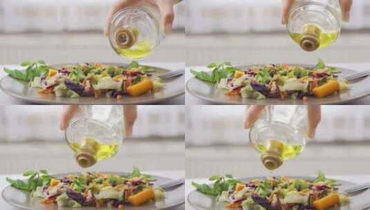 把橄榄油倒在沙拉上高清在线视频素材下载