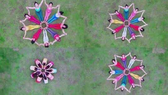多人女性在草地上组成圆圈做瑜伽造型航拍4K高清在线视频素材下载