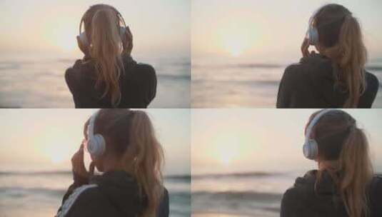 在海边戴耳机听音乐的女生背影高清在线视频素材下载