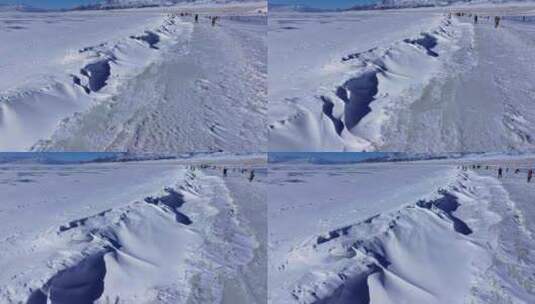 航拍新疆冬季赛里木湖冰封湖面雪山冰湖积雪高清在线视频素材下载