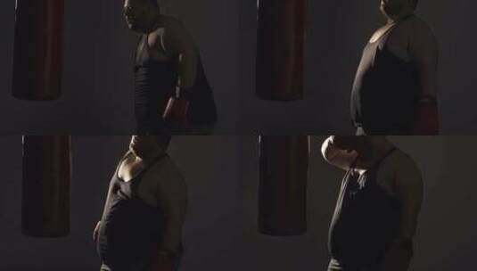 胖子用拳击袋积极锻炼后恢复呼吸，训练高清在线视频素材下载