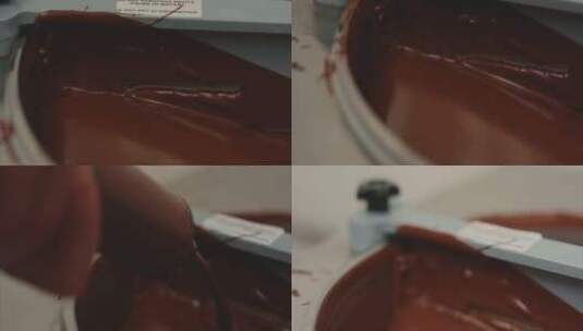 一个人装满巧克力注射器，把巧克力倒在托盘高清在线视频素材下载
