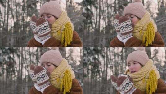 冬季森林里喝热茶的女孩特写高清在线视频素材下载