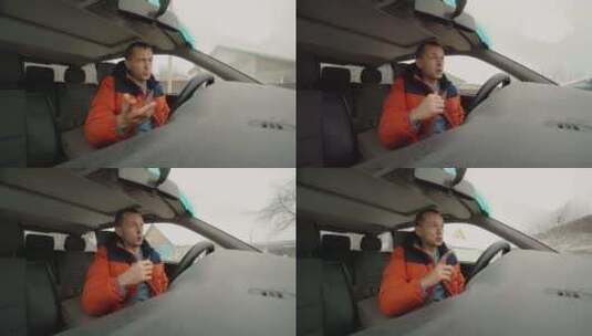男人坐在车里对着镜头说话高清在线视频素材下载