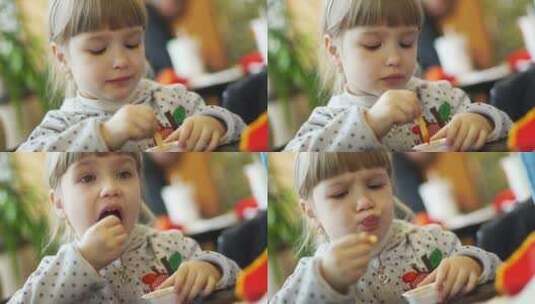 女孩欢乐的吃薯条高清在线视频素材下载