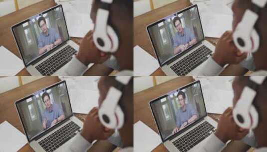 非裔美国男大学生戴着耳机在家里的笔记本电脑上进行视频通话高清在线视频素材下载