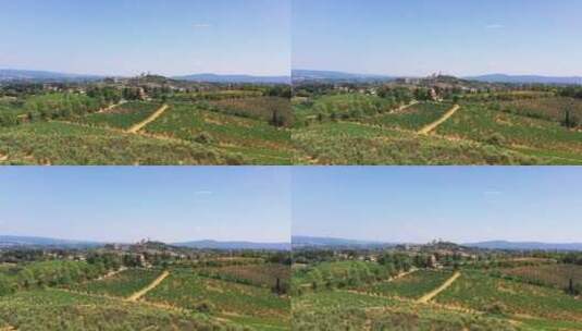 托斯卡纳乡村在葡萄酒田的夏季用无人机拍摄背景中的小村庄高清在线视频素材下载