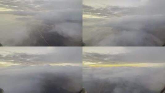 穿越云层的飞机舷窗外的傍晚自然风光高清在线视频素材下载