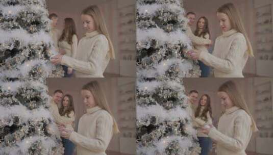 女孩玩圣诞树的球和装饰品高清在线视频素材下载