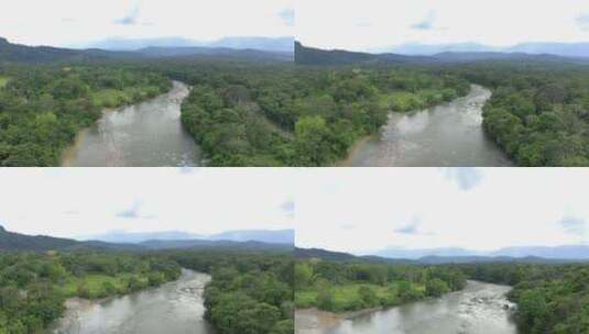 热带大河上的鸟瞰图，一侧有一块开阔的土地高清在线视频素材下载