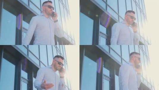 一个戴着深色眼镜的男人在办公楼前打手机时高清在线视频素材下载