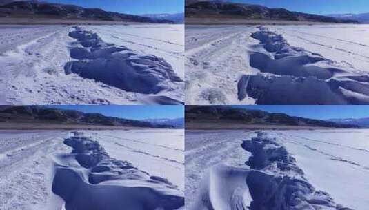 航拍新疆冬季赛里木湖冰封湖面雪山冰湖积雪高清在线视频素材下载