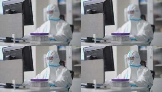 实验室防护服护目镜科研人员比对着试管工作高清在线视频素材下载