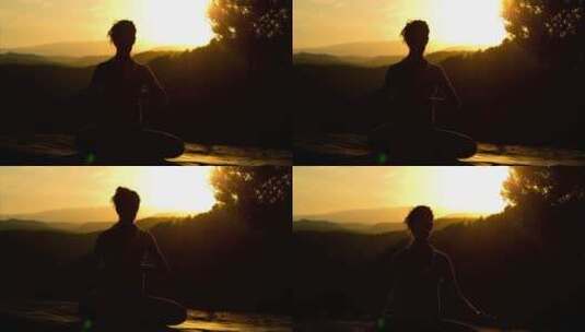 一名女子在日落时做瑜伽的剪影高清在线视频素材下载