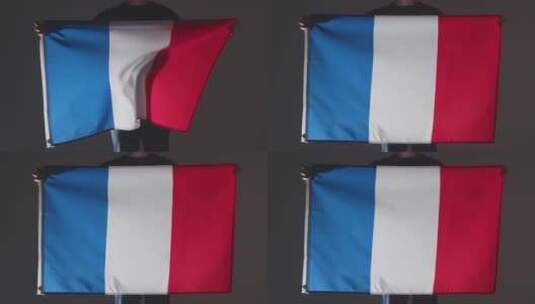 体育迷手持法国国旗在黑色背景下高清在线视频素材下载