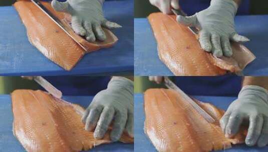 红鱼手工切片的过程。厨师用刀把鱼切成块。缓慢的主题高清在线视频素材下载