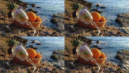 躺在海边的空酒杯跟水果篮橙子高清在线视频素材下载